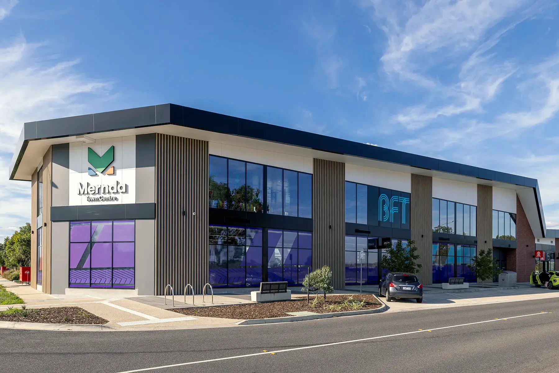 GRC-Mernda-Town-Centre-14: Mernda Town Centre signage and purple glazing on the corner of the Stage 2 building.